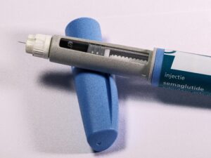 Detailed view of a semaglutide injection pen, commonly used for diabetes treatment, on a plain background.